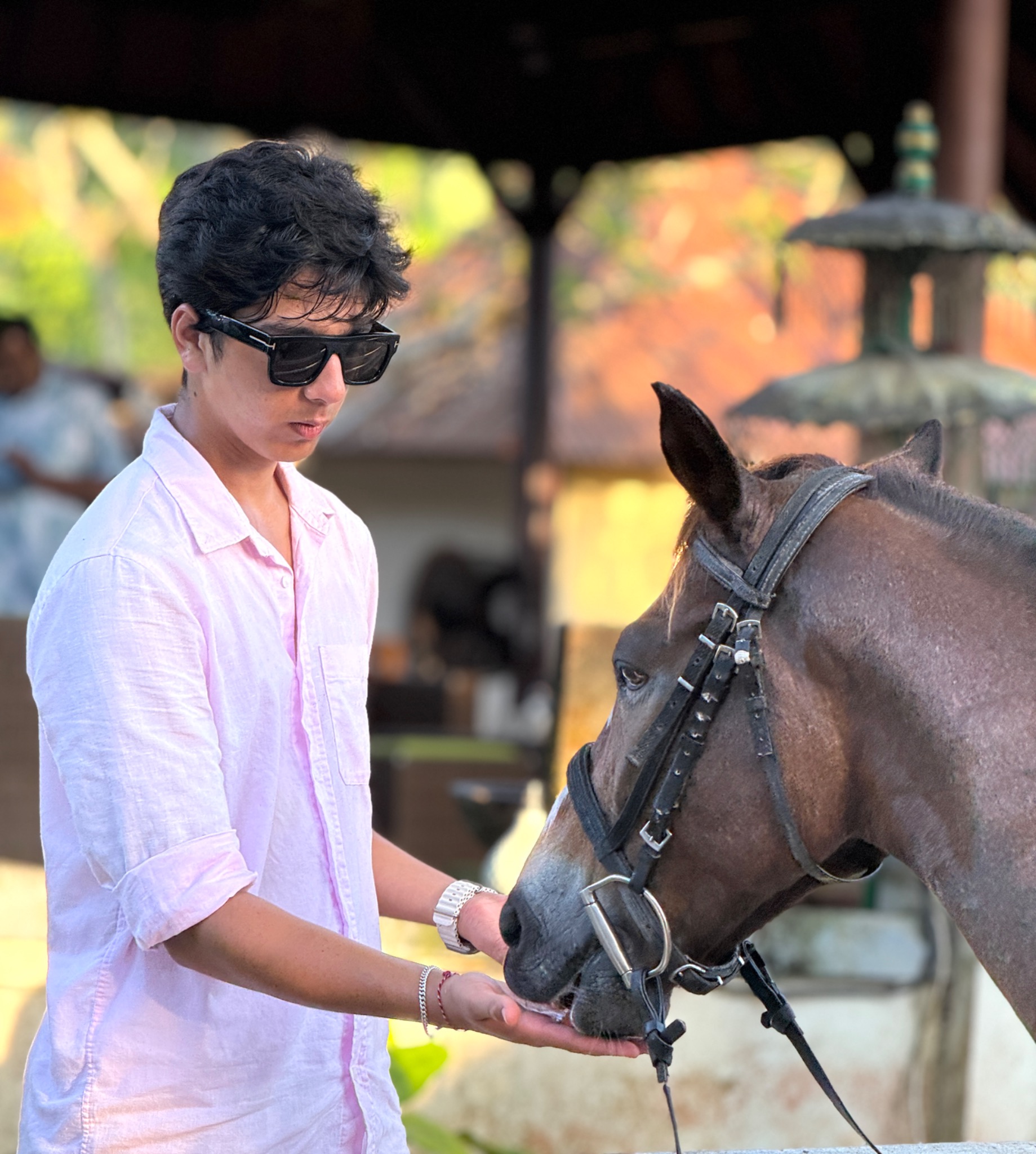 Arnav Ajana standing beside a horse